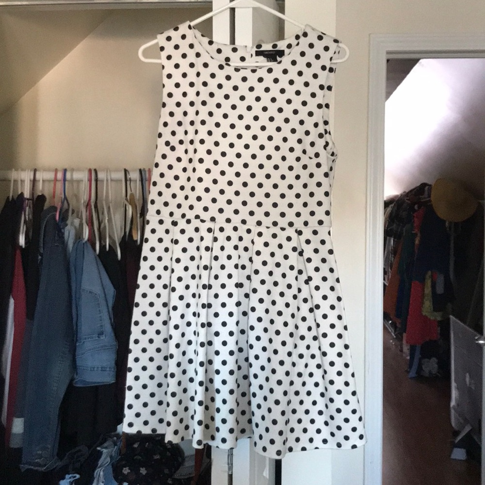 A polka dot dress that is black and white.